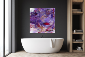 A bathroom with a dark wall and a white bath. On the wall is a beautiful painting with various shades of purple and magenta mingling and swirling almost fluid.