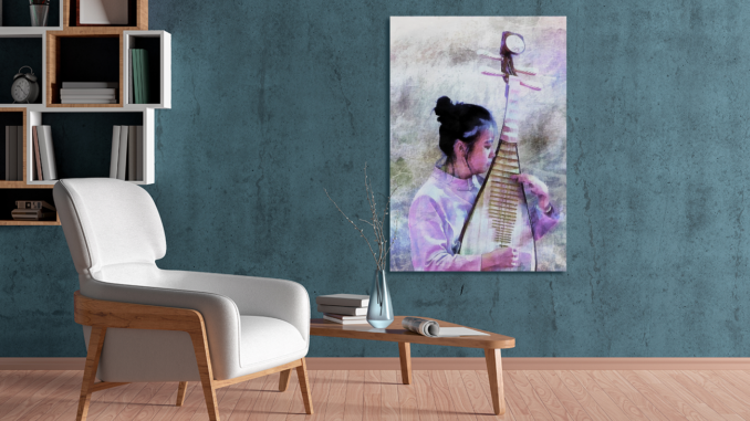 A room with a white armchair and a coffee table and a beige floor, with a grey green wall. On the wall is a print of an image of a chinese girls playing a traditional wooden instrument, the image is in shades of pink and purple.