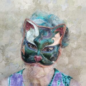 A woman with green hair wearing a cat face mask